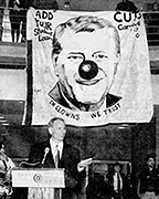 Minister of Education John Snobelen faced student protests in Vari Hall on October 8, 1996. The image is of premier Mike Harris and the text underneath his face reads “In Clowns We Trust.” 