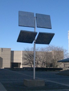 George Rickey’s “Four Squares in a Square” on a warm summer day. The trees in the Central Square Garden and the Curtis Lecture Halls are seen in the background. Photo courtesy the author.